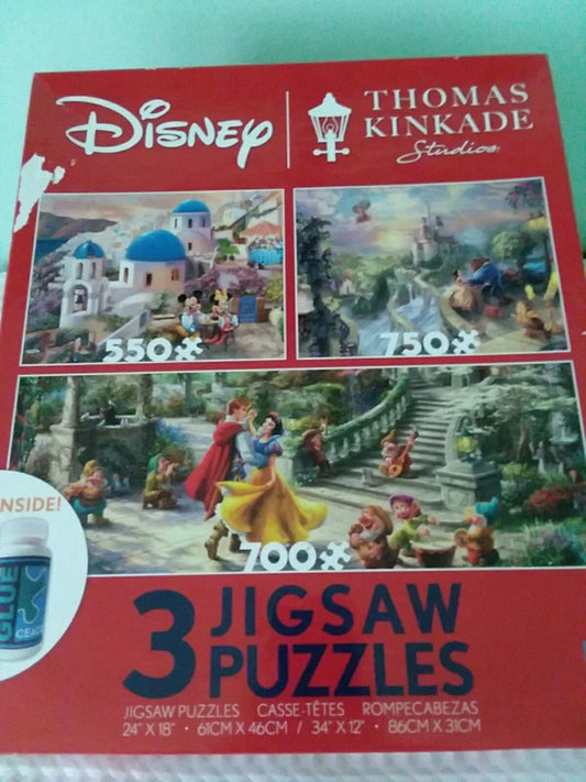 Box of Disney and Thomas Kinkade Studio 3 Jigsaw Puzzles with images of characters and scenery.