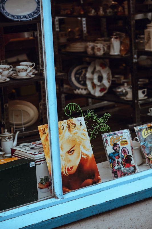 Vintage magazines and collectibles displayed in shop window