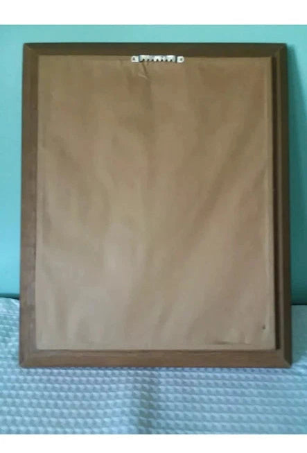 Brown  backing of hanging portrat with branding on a textured surface